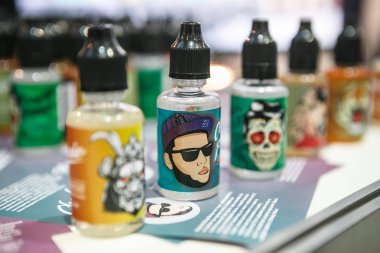 Moscow - 9 Aralık, 2016: Uluslararası Vape Expo.Very popüler modern elektronik sigara sıvı dolum. E-sıvı, e-suyu Satılık plastik şişe kap içinde. ELiquid, ejuice için vaping aygıt becerikli alet, buharlaştırıcı ve vape güvenli bir şekilde doldurun. Hiç nikotin