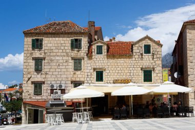 Makarska, Hırvatistan-29 Haziran 2017: Makarska Rivierası beldesinin şehir merkezindeki antik Crotian evi. Yaz tatili için popüler seyahat noktası. Kırmızı çatılı sarı kumtaşı bina