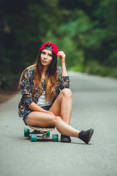 young beautiful fit  woman with  skateboard in park