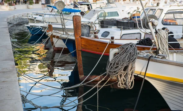 Water crafts tied with rope on pier at popular tourist area in Croatia.Rent motor boat,yacht for summer vacation tour to exotic islands.travel destination for summer vacation cruise.Rental boats in haven