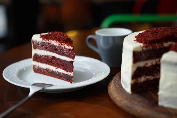 stock image Piece of delicious piece of cake cut & served on white plate in restaurant. Enjoy sweet food for dessert in cafe