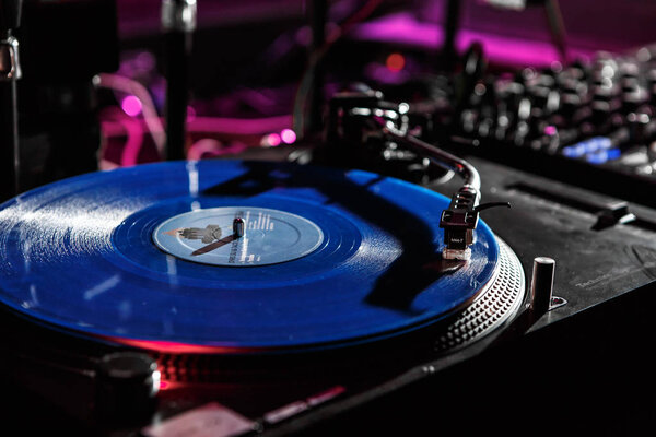 KIEV-4 JULY,2018: Retro Technics SL-1210 turntable vinyl records player on stage.Professional vintage dj audio equipment on concert scene.Shure M44 needle scratch analog record with music in the club