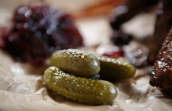 Pickled cucumber served on brown paper in fast food restaurant menu.Food close up