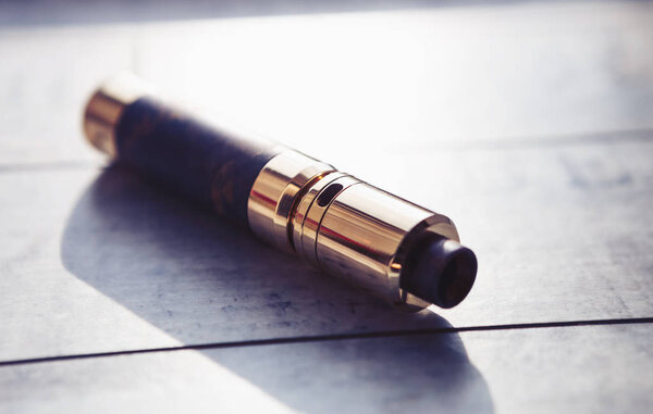 Modern electronic mech mod vaping device.New vaporizer e-cig gadget to vape glycerin e-liquid.Quit smoking nicotine cigarette, start vaping safe ecig vape
