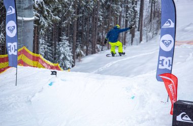 Bukovel, Ukrayna-19 Mart, 2018: Genç snowboard atlet rampa Kayak Park Bukovel kış kar tahtada yapmak hava hüner Park.Sportsman yarışmada doğa kış sporları sırasında atlar