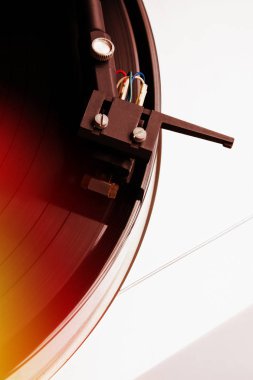 Turntable playing vinyl record with music. 