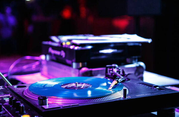 KIEV-4 JULY,2018: Retro dj Technics turntables with vinyl records on concert stage in music hall.Professional disc jockey audio equipment on electronic festival in nightclub