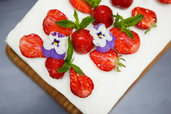 Eat sweet creamy cake with biscuit, white sugar cream & fresh strawberries on topping.Delicious Italian restaurant dessert menu dish.Enjoy strawberry cake for lunch break in cafeteria