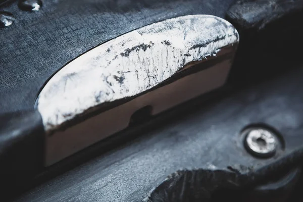 Scratched backslide plate and grind block on used aggressive inline skates for extreme skating.Professional specialized skate model to grind rail or ledge in street skatepark.Close up,focus on plates