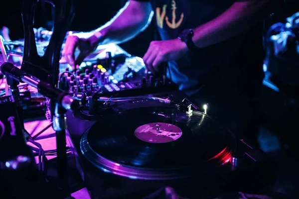 KIEV-4 JULY,2018: Retro Technics turntable player for disc jockey. DJ DOC plays music set on stage in nightclub with professional audio equipment setup. Turn table with vinyl record on techno music party in the club