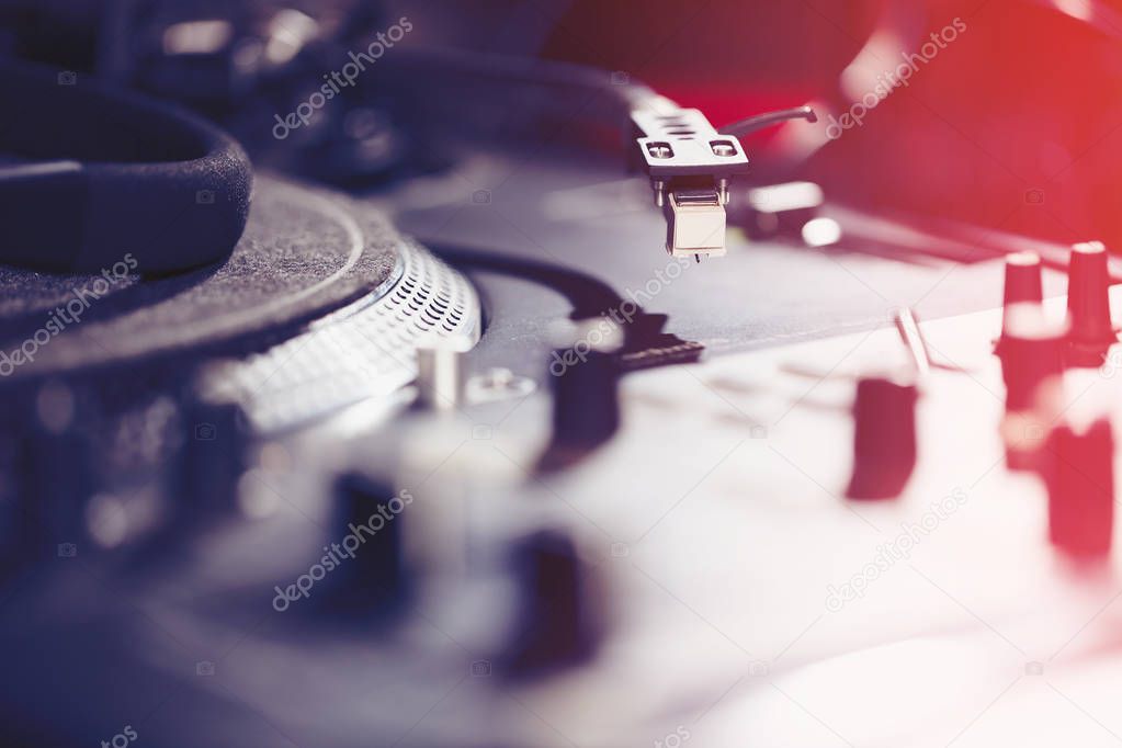 Turntable vinyl record player, analog sound technology for DJ playing analog and digital music. Close up, macro of equipment for professional studio