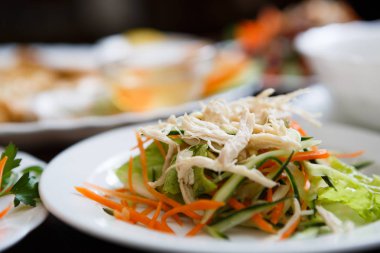 Beyaz haşlanmış tavuk eti, dilimlenmiş taze salatalık ve havuç Asya kafede beyaz tabakta iyi diyet Çin salatası. Egzotik yiyecek Restoran geleneksel Vietnam mutfağında.