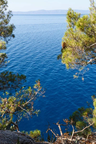 Deep blue sea water in Crotia.Top view on Adriatic Sea coast.Bautiful nature in good sunny day.Vertical seascape.Travel destination for summer vacation travel in Europe.Tropical island view