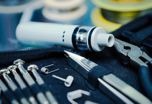 Vape shop.Modern vaping device maintenance & upgrade parts in close up.Buy popualr ecig vaper device.Electronic cigarette gadget for smoking ejuice.New box mod clearomizer