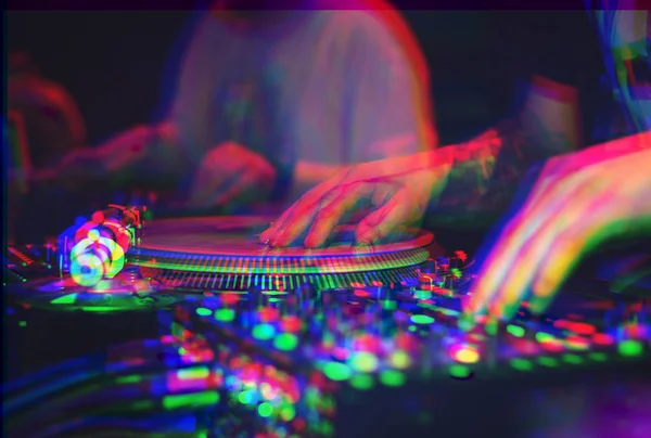 Hands of hip hop party dj scratching vinyl records with music on concert in nightclub edited with vintage glitch effect.Disc jockey plays musical set in the club on stage.Sound mixer & turntables