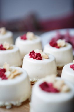 Beyaz krema ve ahududu tepesi ile tatlı kek ye. Lezzetli İtalyan Restoran pastane. Tatlı menüsü kafede. Küçük kek yemek keyfini çıkarın. Lezzetli pasta ürün, yakın