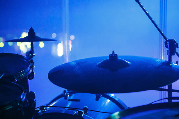 MOSCOW - 30 NOVEMBER, 2016 : Drummers drum set on scene in bright lights.Drums in focus. Professional concert audio drumming equipment. Musical instruments in blue light