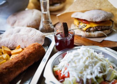 Geleneksel Sırp Shopska salatası, taze girlled burger ve alkollü meze fast food restoran tabloda alınarak atış iç. Egzotik yiyecek Cafe menü yemek. Restoranda lezzetli akşam yemeği