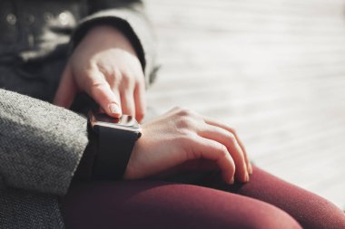 Erkek bankta oturan onun modern akıllı kol saati kullanarak. Bu kişi her zaman sosyal medya ve internet bağlı.