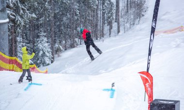 Bukovel, Ukrayna-19 Mart, 2018: Genç snowboard atlet rampa Kayak Park Bukovel kış kar tahtada yapmak hava hüner Park.Sportsman yarışmada doğa kış sporları sırasında atlar