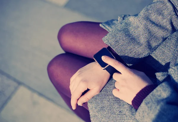 Womanusing her trendy smart wrist watch.