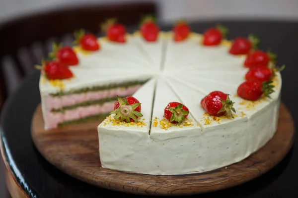 delicious sweet Italian cake with pistachio & strawberry biscuit decorated with fresh strawberries in syrup.