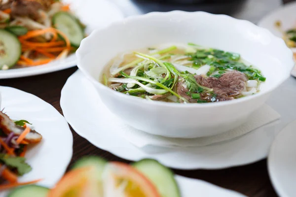 Delicious Vietnamese tradition restaurant food pho bo soup.Natural exotic food menu.Tasty Asian hot dish with beef meat & noodles served in bowl