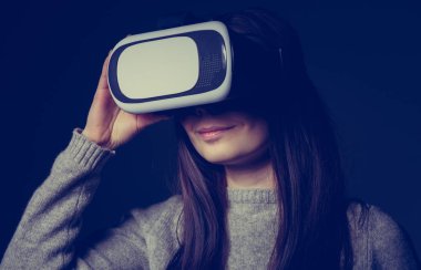 Stüdyo mobil oyun uygulamalar için yeni artırılmış gerçeklik gözlük kullanan genç ve güzel kız portresi. Mobil Oyunlar apps ile yenilikçi 3d vr kulaklık kullanın. Trendy sanal gerçeklik oyun aygıtı kullanımda
