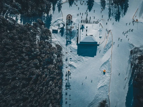 Beautiful aerial drone landscape shot of Carpathian mountains in cold winter day.Forest trees and snow in Carpahtians in overhead view.Travel destination for active tourism in Southern Europe