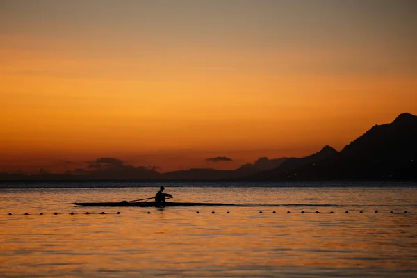 Young athlete sail on kayak boat in Adriatic Sea at sunset.Healthy and strong tourist guy rides on canoe in Croatia.Fun water sport