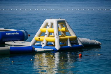 MAKARSKA,CROATIA-16 JUNE,2017:Inflatable bouncing castle on water in Croatian Riviera.Popular travel destination for family tourism.Fun inflatable playground for children on vacation