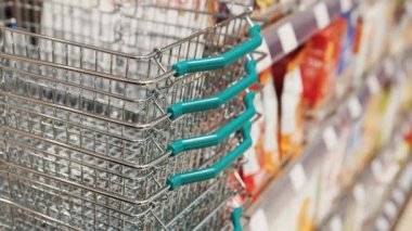 Süpermarketteki boş metal alışveriş sepetlerinin görüntüleri. Gıda mağazası, ürün satın almak ve bu sepette taşımak. Model yok.