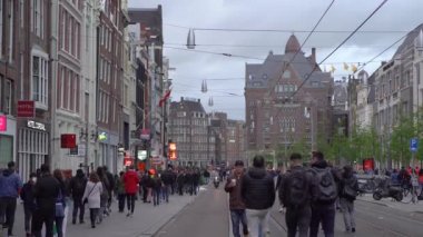 AMSTERDAM, NETHERLANDS - 28 Nisan 2019: Amsterdam 'ın merkezinde insanlar her yıl düzenlenen Kral Günü' nü (Flaman: Koningsdag) kutluyorlar. Hollanda Krallığı 'nın popüler ulusal bayramı. Eski kentte yürüyen turistler     