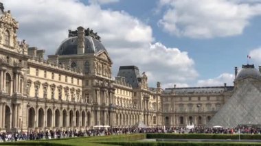 Paris,Fransa-30 Nisan,2019:En ünlü Fransız simgesi - Louvre Museum.Footage güzel müze kompleksi, çeşme ve cam inşaat dünyanın dört bir yanından gelen turist kalabalığı ile çevrili 