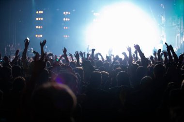 Concert stage lights and crowd on dance floor partying to the music clipart