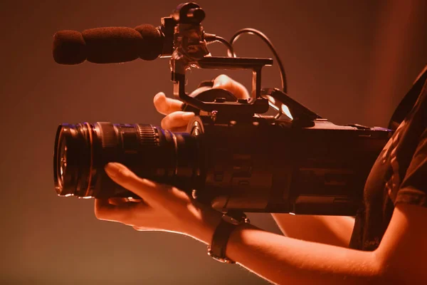 Video operator woman films concert event with professional camera