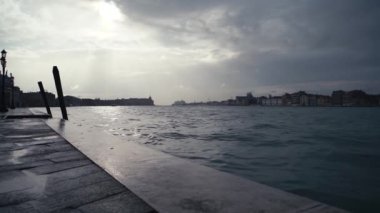 Beautiful Grand Canal in Venice after the storm.Dramatic cloudy sky in Venezia at dusk.Popular travel destination for cultural tourism in Europe.Venetian canals and old houses on background