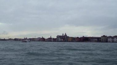 VENICE,ITALY-4 May,2019:Footage panorama of venetian lagoon and Metropolitan City of Venezia in rainy spring day shot from moving boat.Popular tourist destinatioin in Europe in low season