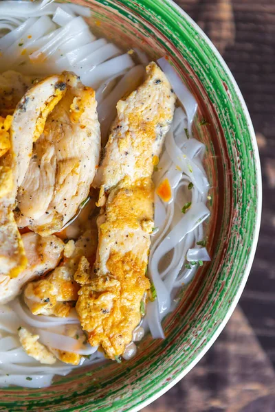 チキンストリップのスープで調理されたラーメン麺 東洋のカフェで夕食のためのスパイシーな鶏肉と米麺で調理されたおいしいアジアのスープ — ストック写真
