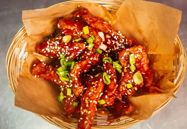 Deep fried chicken strips served on paper for take away menu in fast food restaurant.Delicious frying poultry fillet meat served with sesame & green onion.