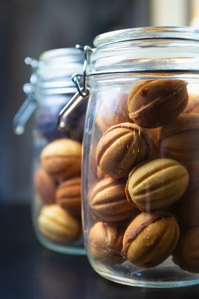 Walnuts with condensed milk baked in oven with traditional Russian recipe for dessert meal.Delicious pastry products in glass jar cooked for coffee break.