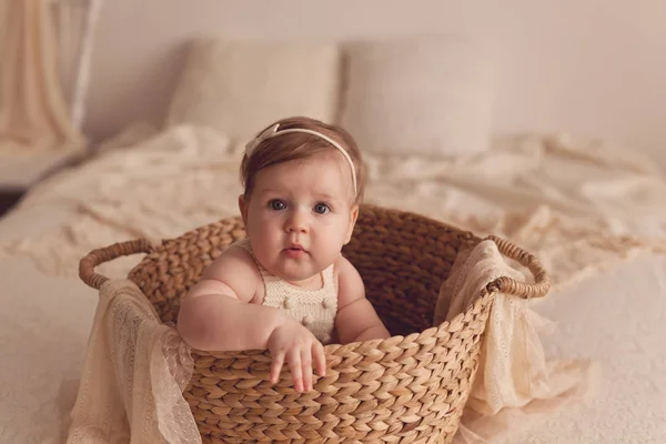 一个坐在柳条篮子里的六个月大女孩的画像 — 图库照片