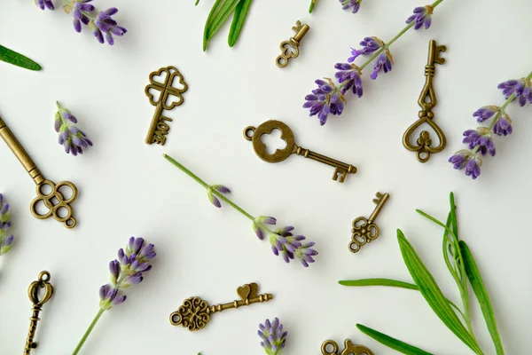 Lavender flowers and decoration keys  flat lay on white background