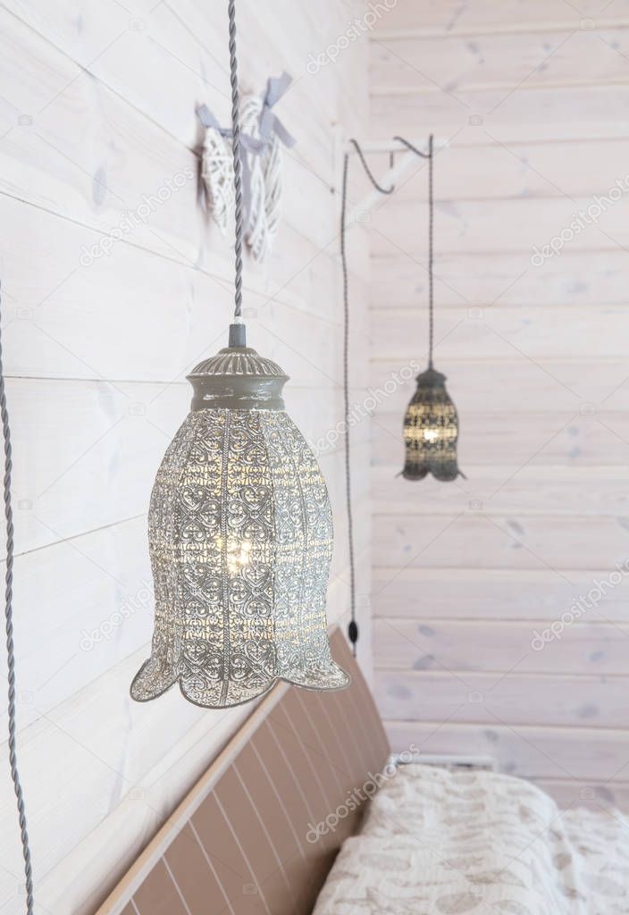 Vintage lamps hanging on a white wooden wall.