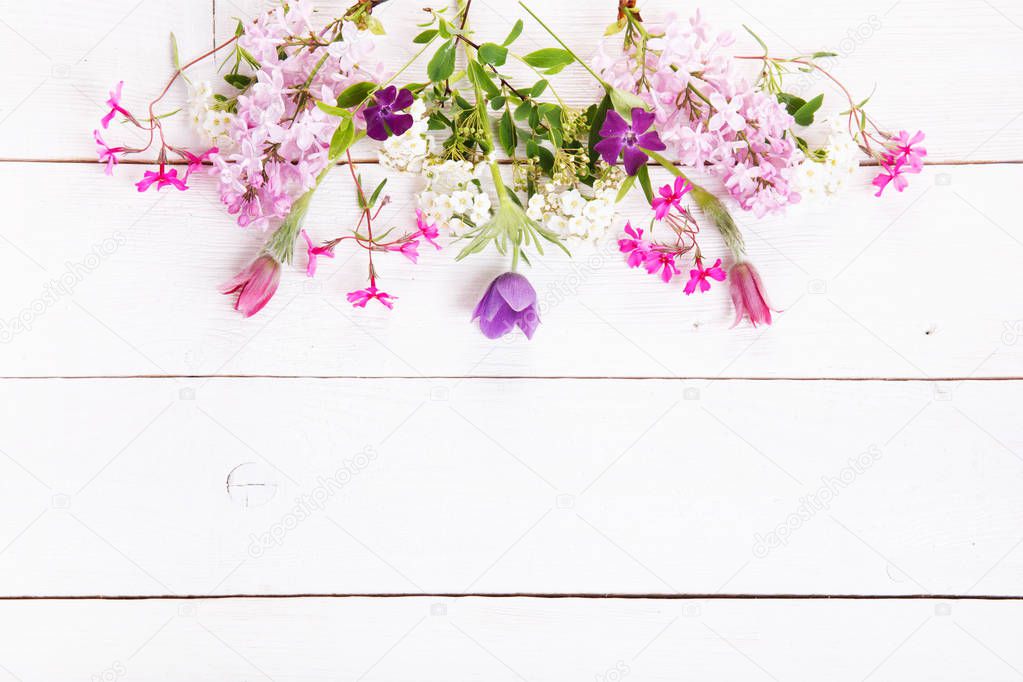 Festive flower composition on the white wooden background. Overhead view