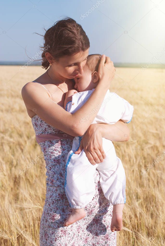 Happy Family outdoors - walking at the Summer wheat field - happy healthy child with mother