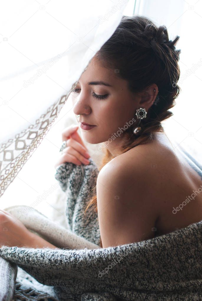 Young beautiful woman in the interior - pure skin concept