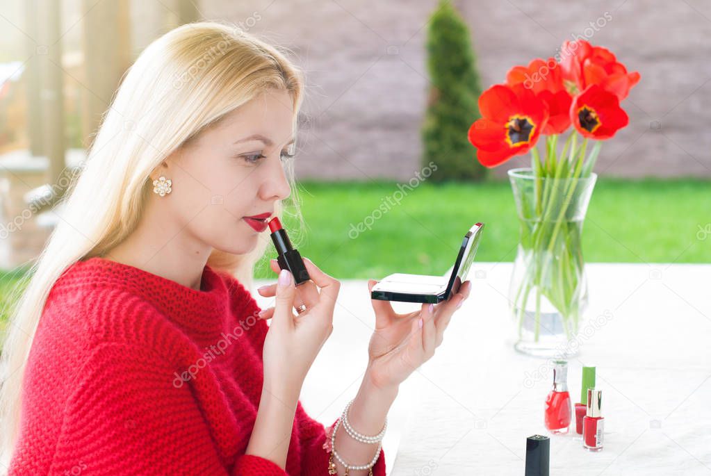 Portrait of young Beautiful Blonde Woman making make up