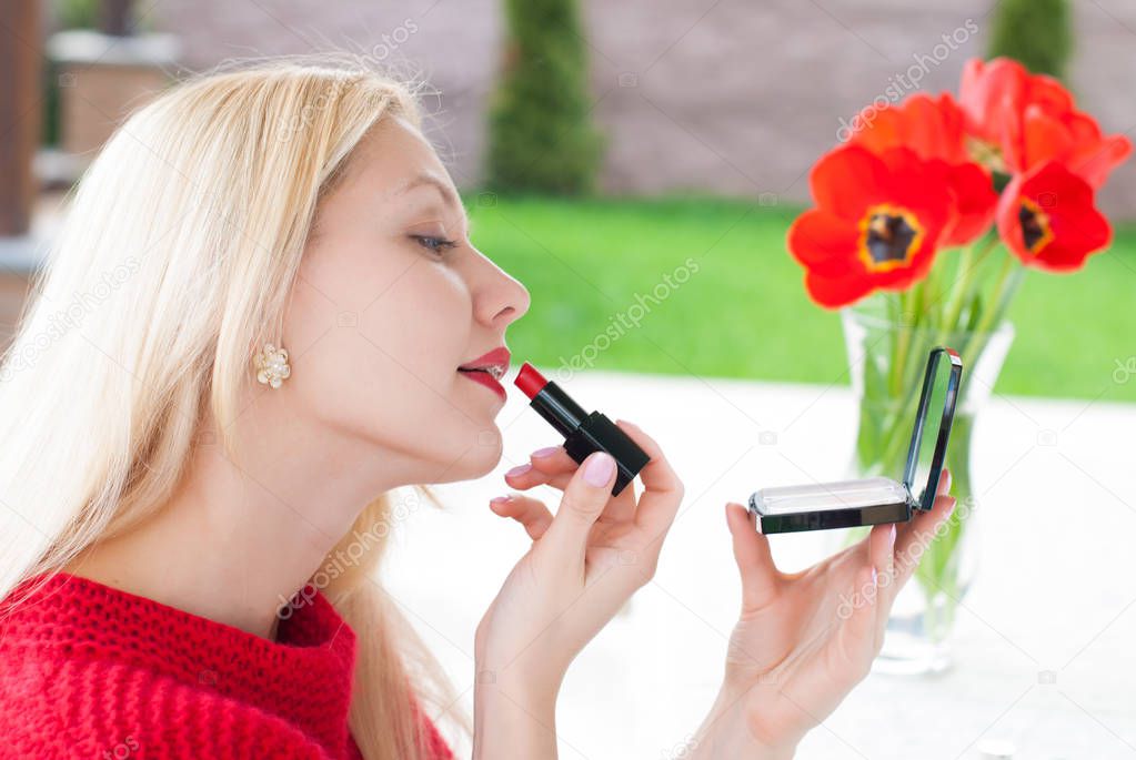 Portrait of young Beautiful Blonde Woman making make up