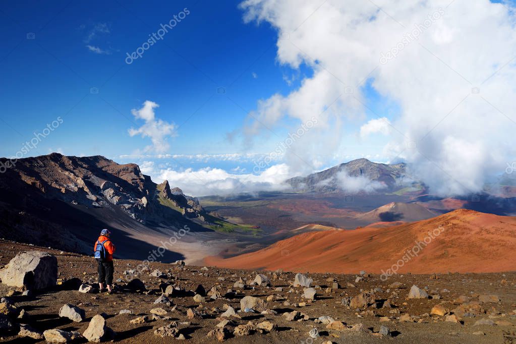 Tourist hiking in Haleakala volcano crater on Sliding Sands trail, Maui, Hawaii, USA